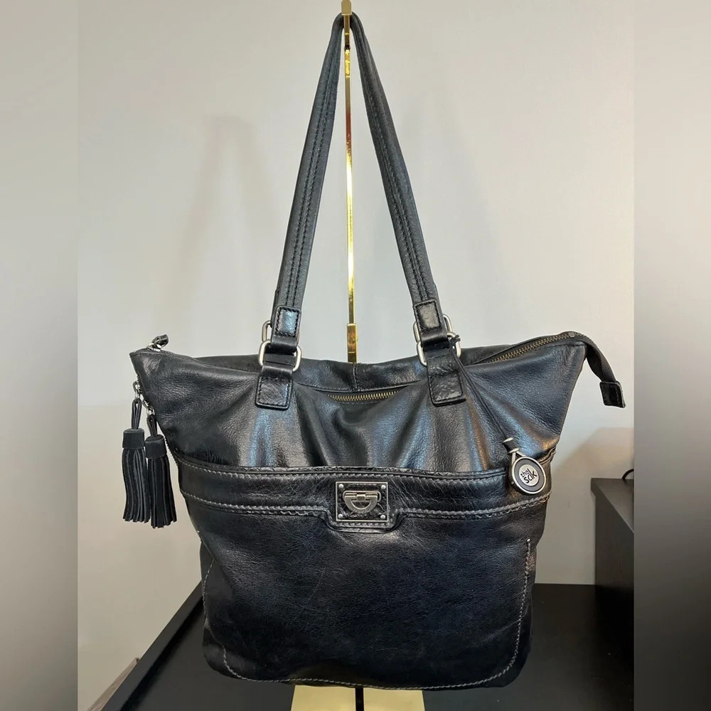 The Sak Expandable Black Leather Suede Shoulder Tote Bag with Suede Tassels